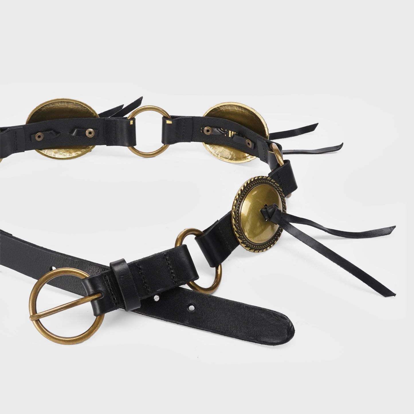 Black leather belt with brass conchos and tassels