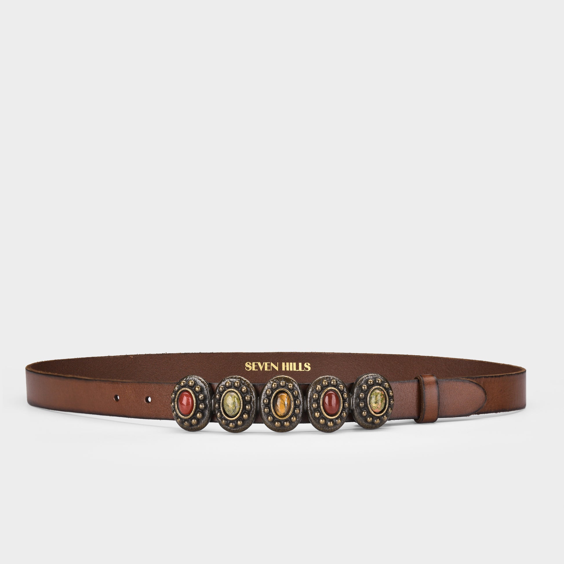 Brown belt with decorative studs and 'Seven Hills' branding on a light gray background